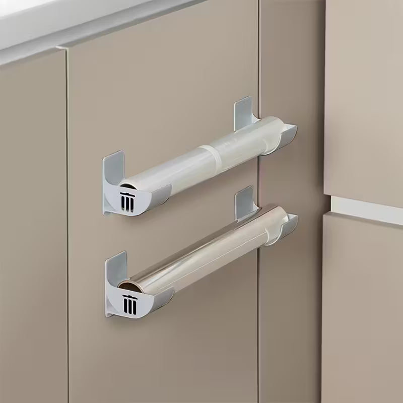 Pilkas sieninis šiukšlių maišelių laikiklis su lipnia tvirtinimo juosta virtuvei ar spintelėms.