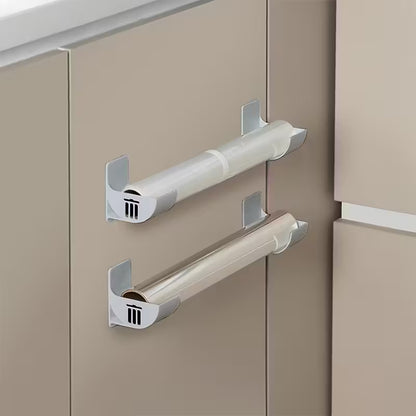 Pilkas sieninis šiukšlių maišelių laikiklis su lipnia tvirtinimo juosta virtuvei ar spintelėms.