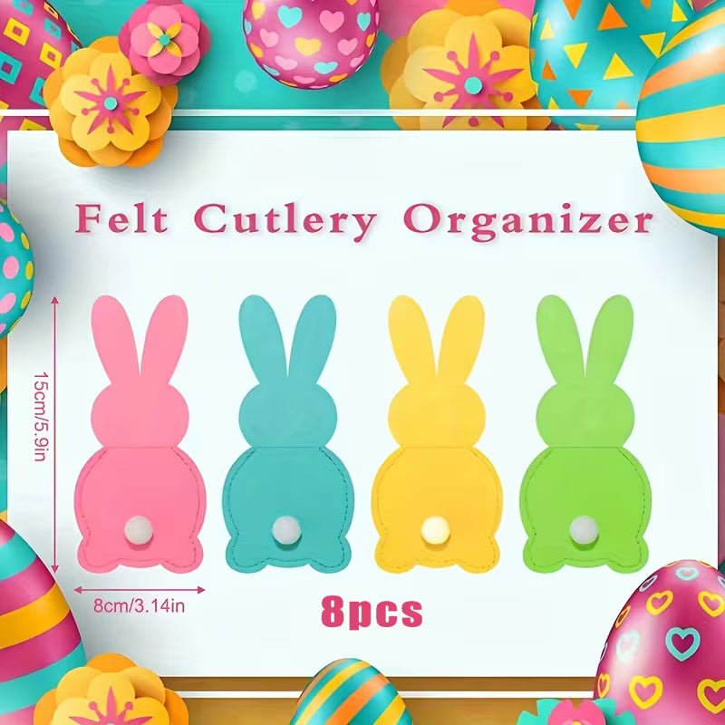 Velykų stalo dekoracija: ryškūs stalo įrankių laikikliai tvarkingai laikantys šakutes, peilius ir šaukštus.